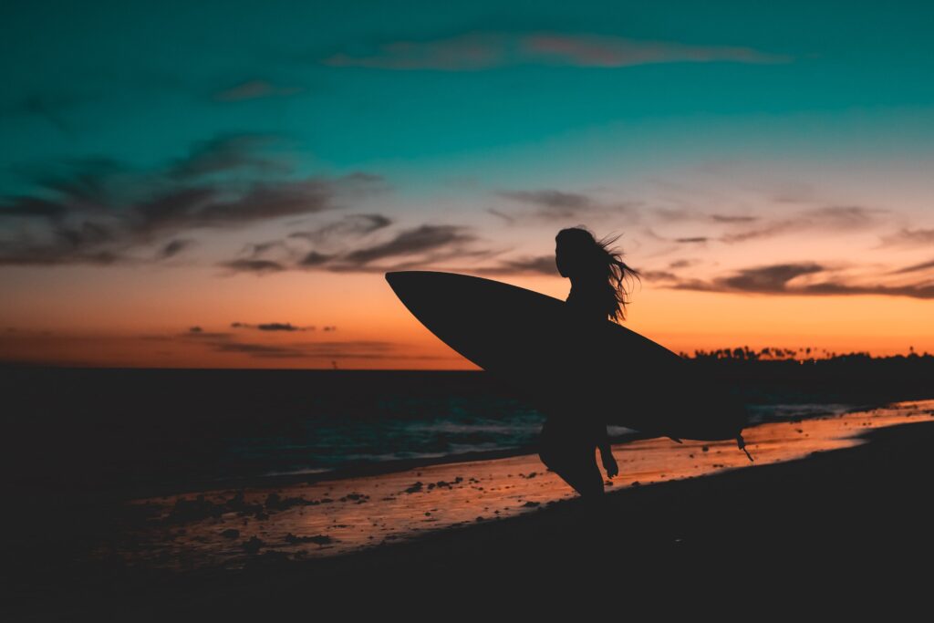 Fit surfer at dusk.