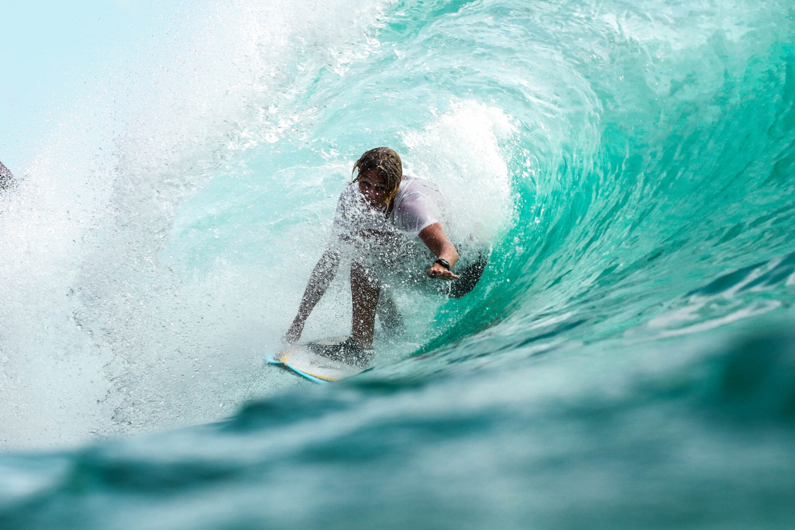 Surfer focused on going through a tunnel in a wave.